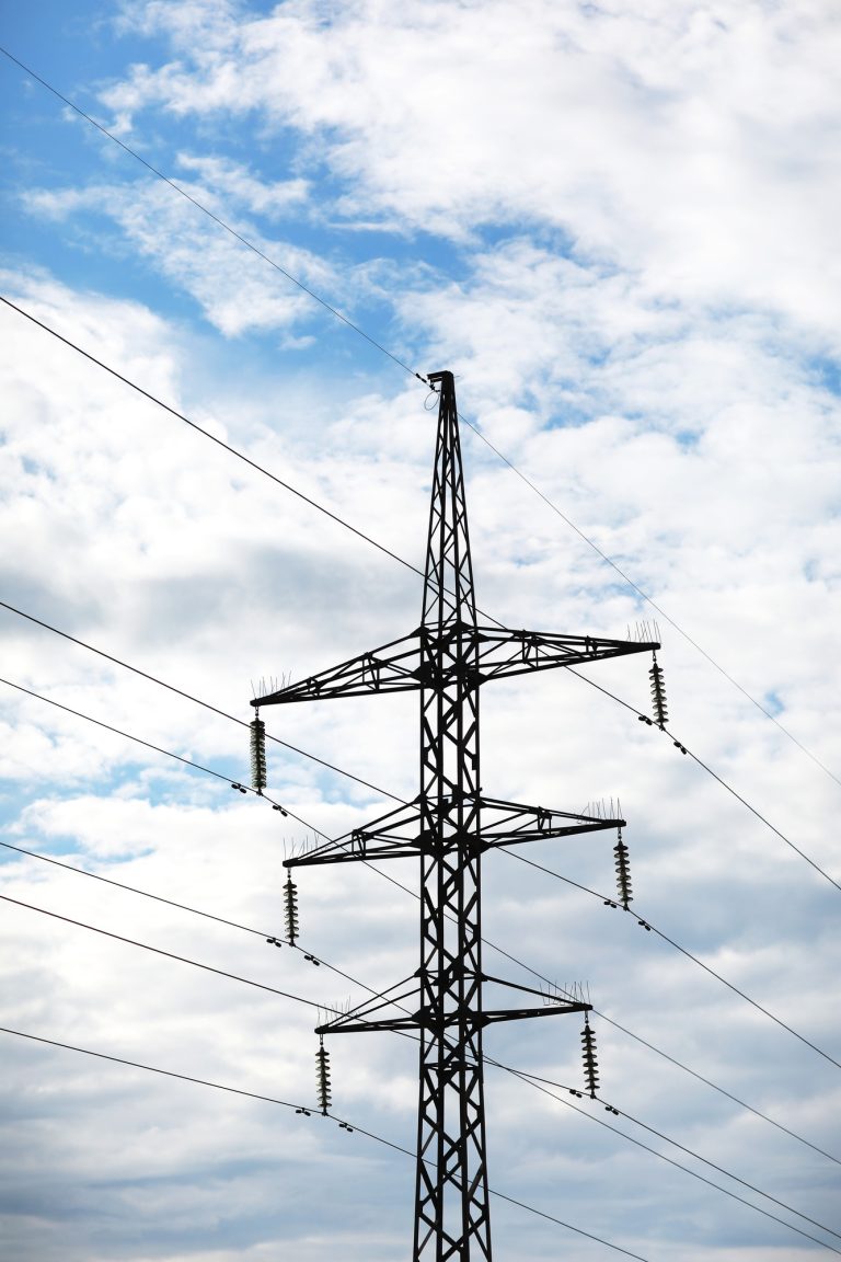 high-voltage power lines on blue sky background. electricity distribution station. Electrical net